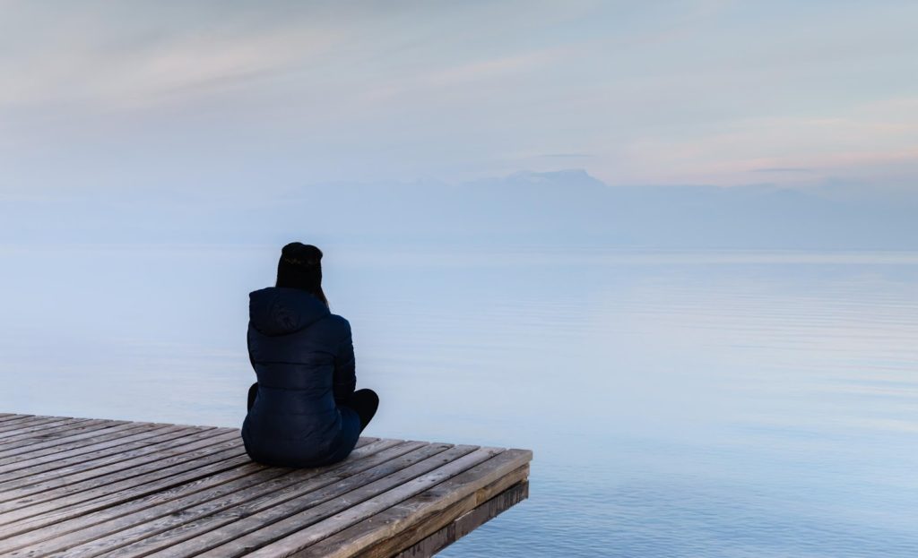  A girl sitting alone on the beach 