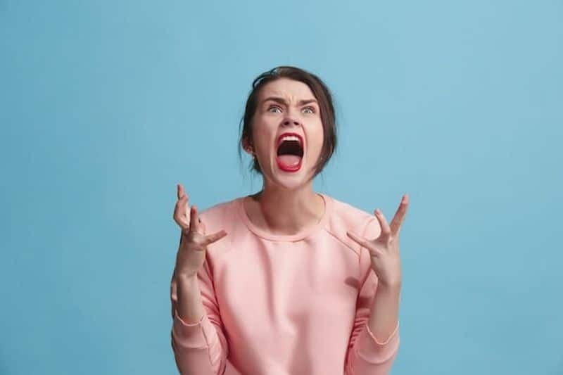  A girl shouting, very angry.
